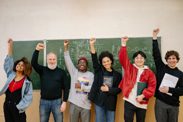 A cheerful group of diverse students and a teacher celebrating in front of a chalkboard full of equations.